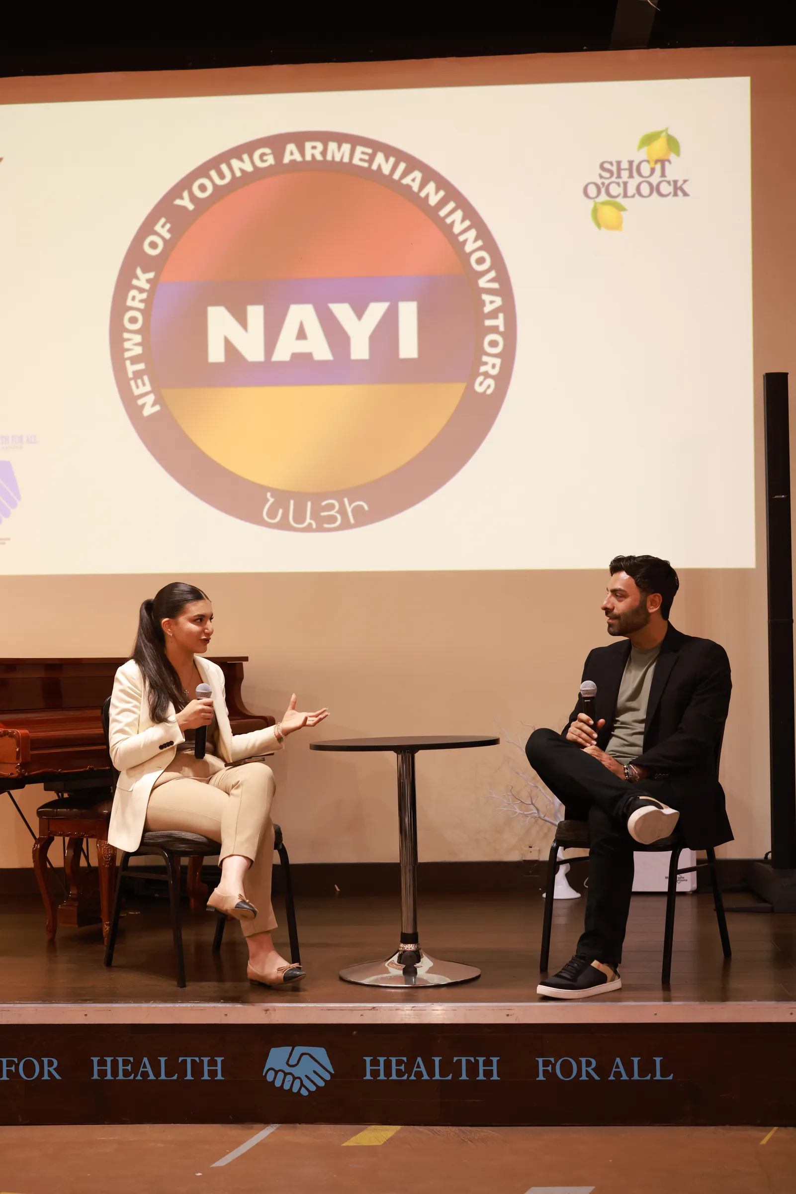 Two speakers in conversation at a NAYI event