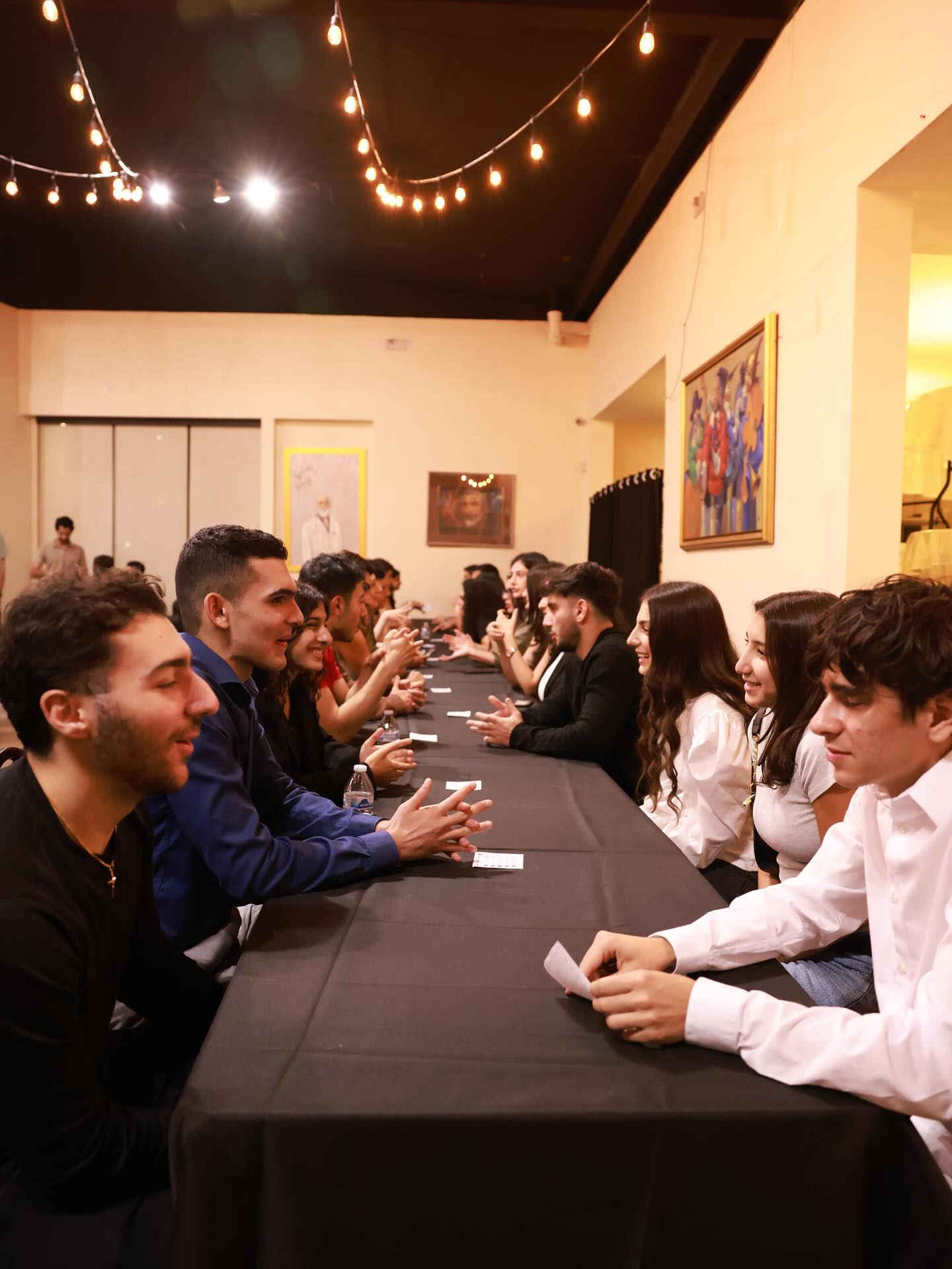 Young Armenians talking together at a NAYI event.